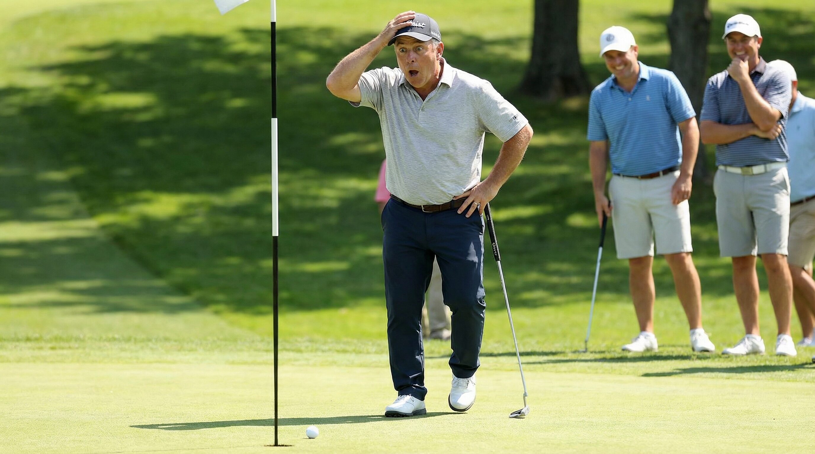 A golfer missing a putt and looking surprised, as if this never happens to them.