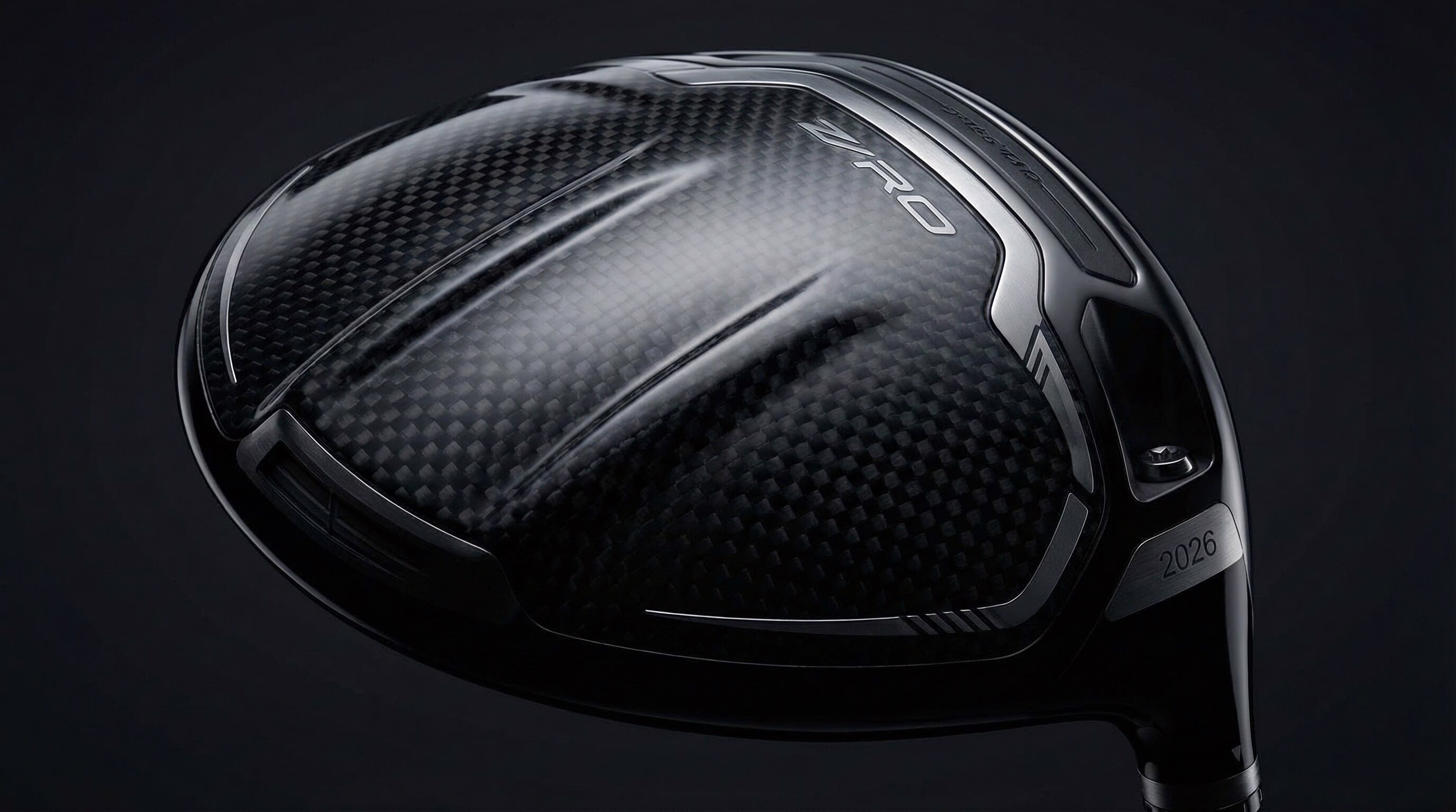Close-up of the carbon fiber crown on a modern 2026 golf driver.
