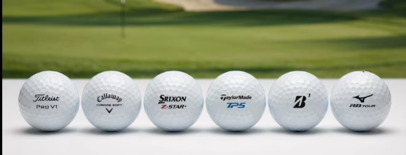 A lineup of premium golf balls from Titleist, Callaway, Srixon, TaylorMade, Bridgestone, and Mizuno on a white surface with a golf course in the background