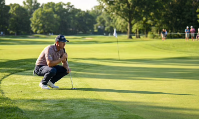 golfer reading putt on championship green