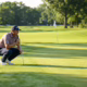 golfer reading putt on championship green
