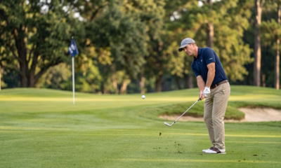 Weekend golfer hitting a partial wedge shot from short range into the green