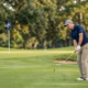 Weekend golfer hitting a partial wedge shot from short range into the green