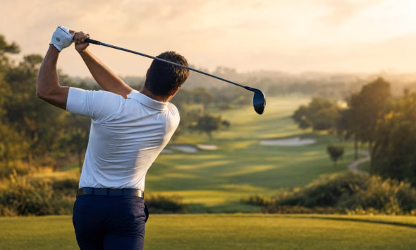 How to Hit a Draw — hero image showing a golfer at the top of the backswing from a down-the-line view