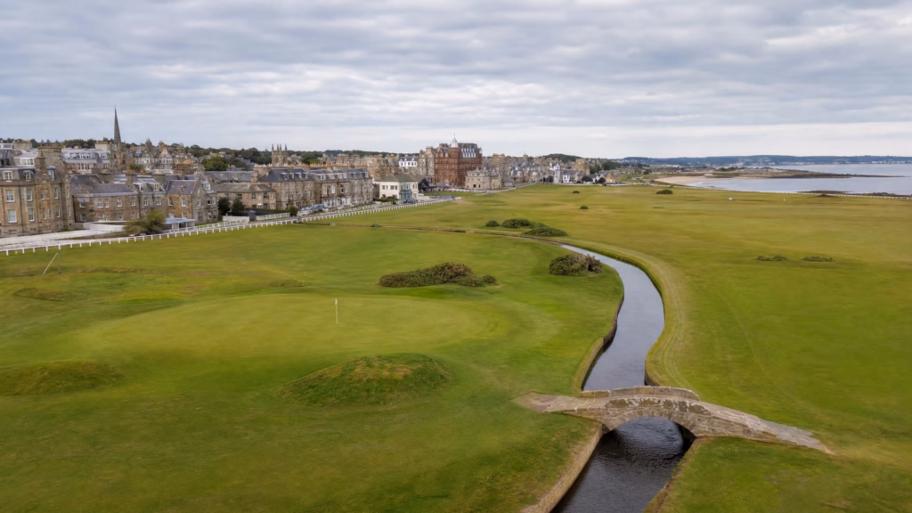 Aerial view of St Andrews Old Course with the Swilcan Bridge and historic town skyline — best golf destinations 2026