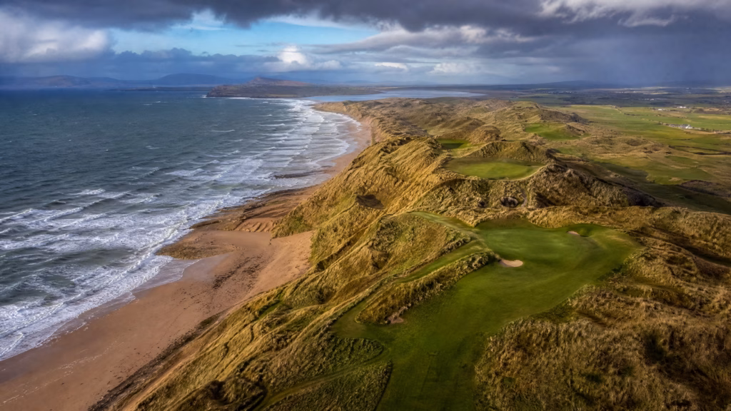 Aerial view of an Irish links golf course on the southwest Atlantic coast with towering sand dunes — best golf destinations 2026