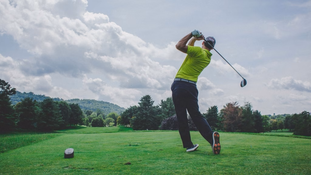 Golfer considering a target line before a shot, a key part of golf course management strategy.